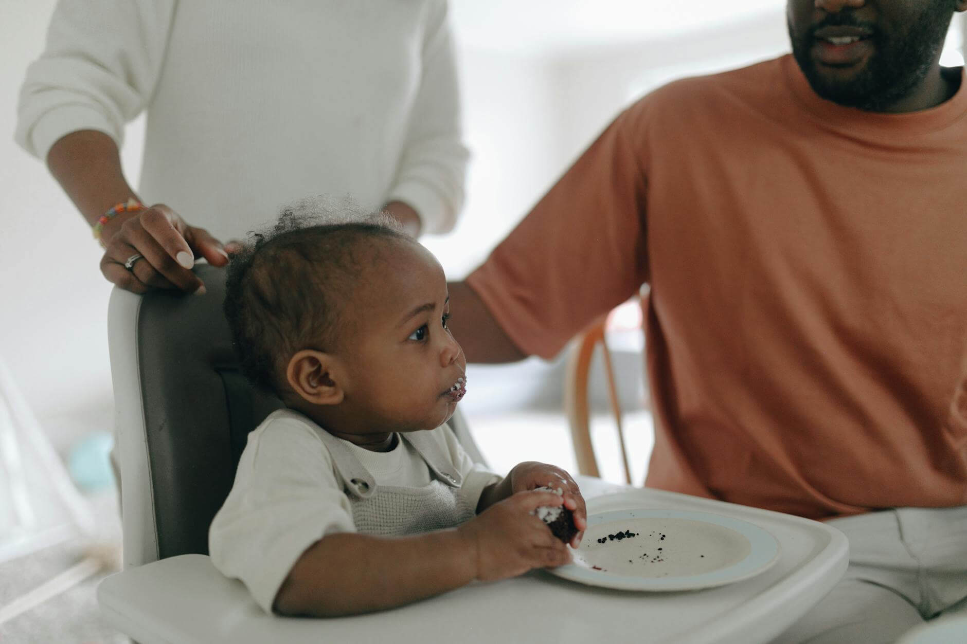 photo of a baby eating a cake